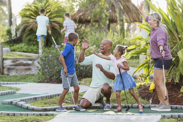 family playing putt-putt golf